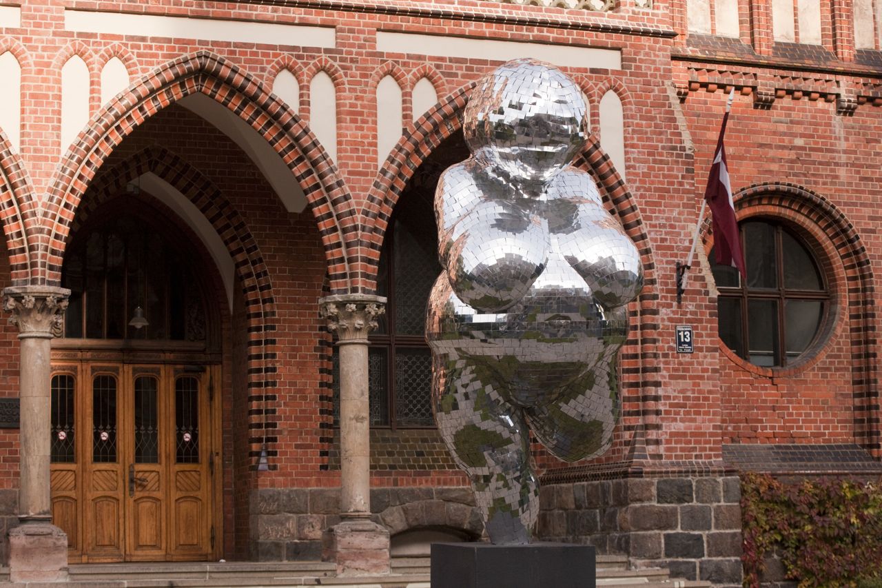 photograph of a recreation of sculpture venus of willendorf. the statue is covered in mirrors.